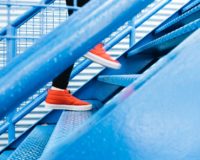 person stepping on blue stairs