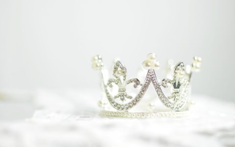shallow photography of silver-colored crown