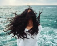 woman standing near body of water during daytime