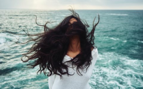 woman standing near body of water during daytime