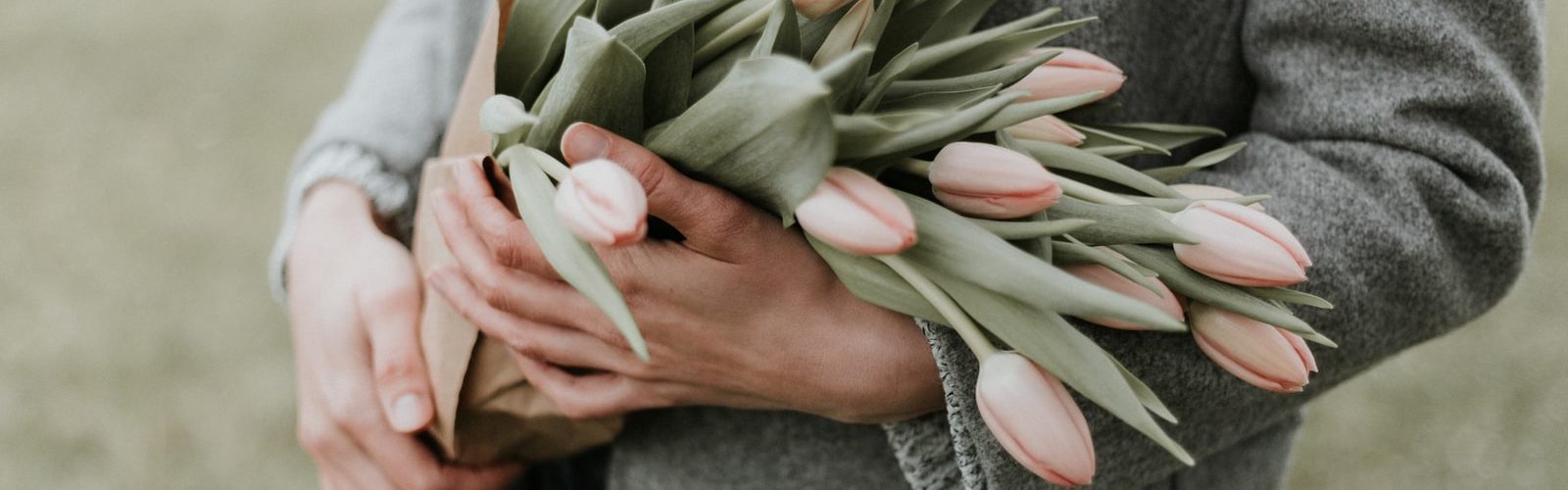 person holding bouquet of tulip flowers