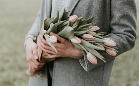 person holding bouquet of tulip flowers