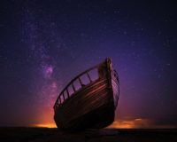 silhouette photography of sailing boat on body of water