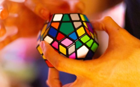 person holding 3 x 3 rubiks cube