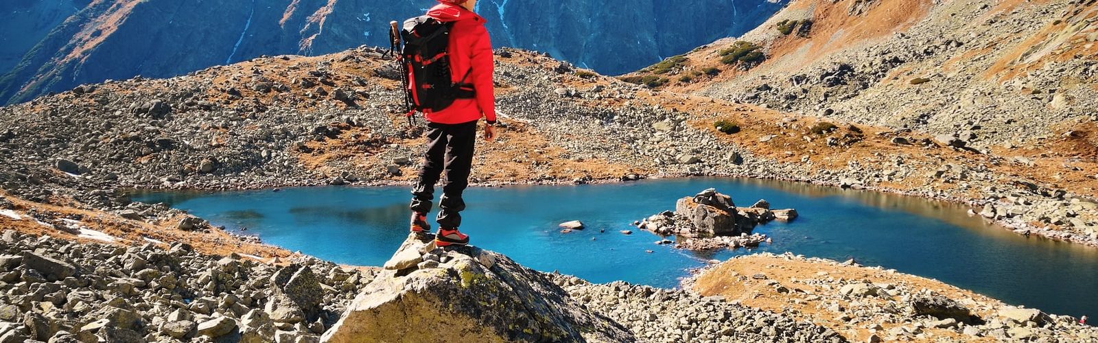 man standing on rock during daytime