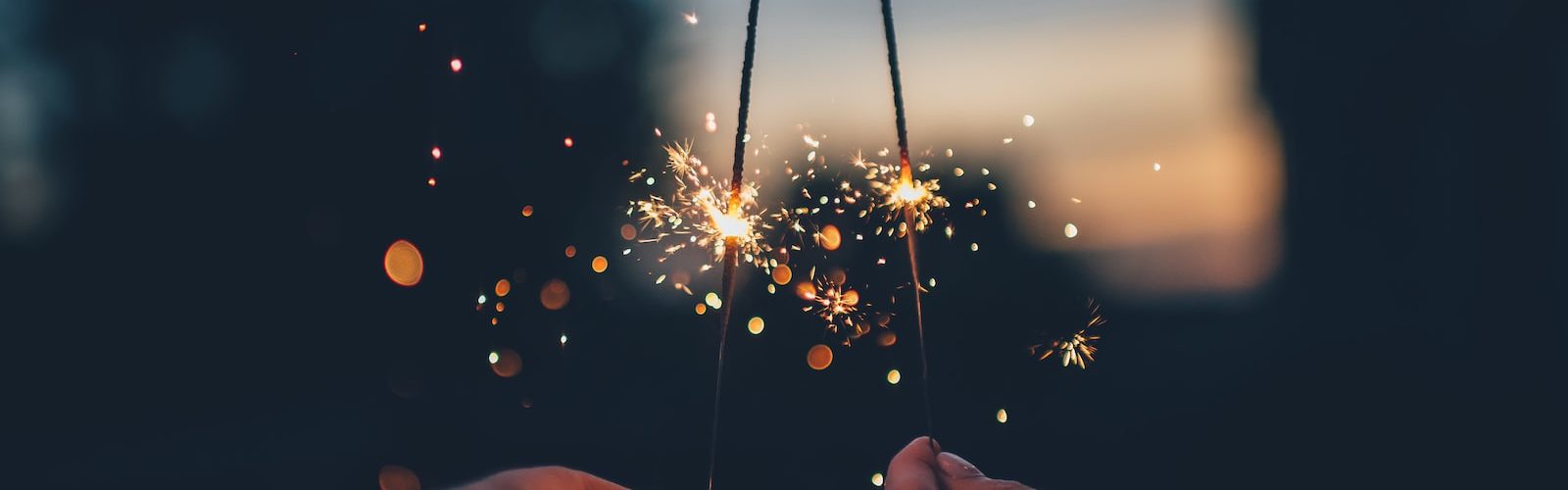 person holding fire cracker shallow focus photography