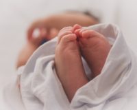 baby covered with white blanket