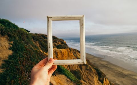 person hand holding photo frame