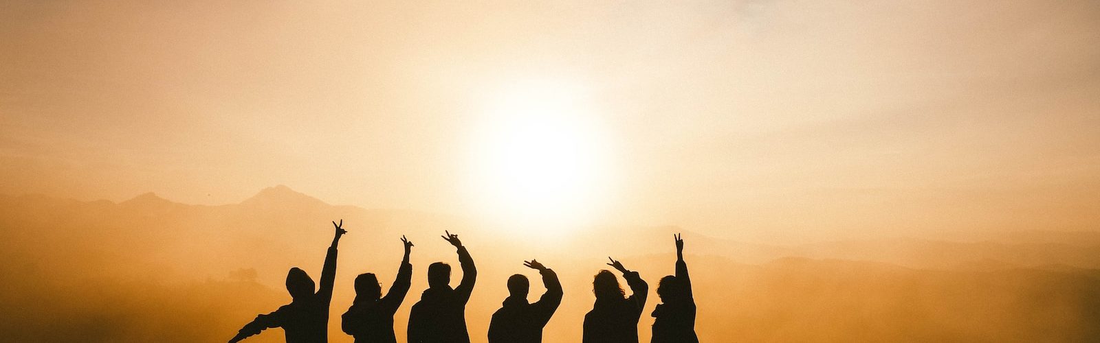 silhouette photo of six persons on top of mountain