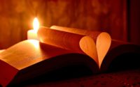 lighted candle on brown wooden table