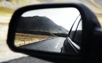 black wing mirror showing road