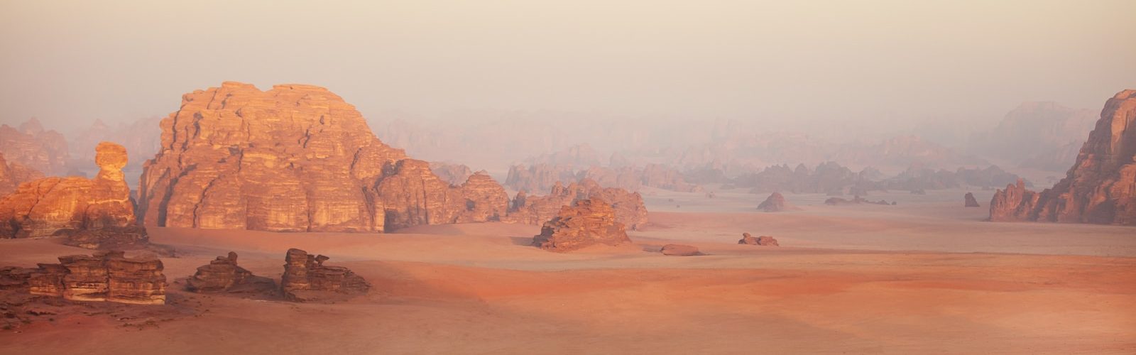 a lone person standing in the middle of a desert